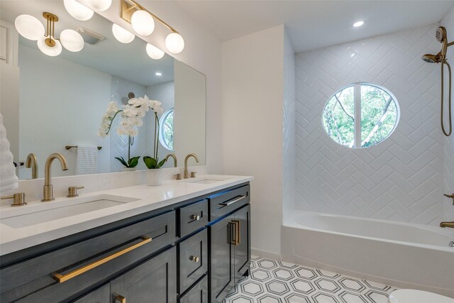 bathroom with double vanity, a sink, shower / bath combination, and recessed lighting