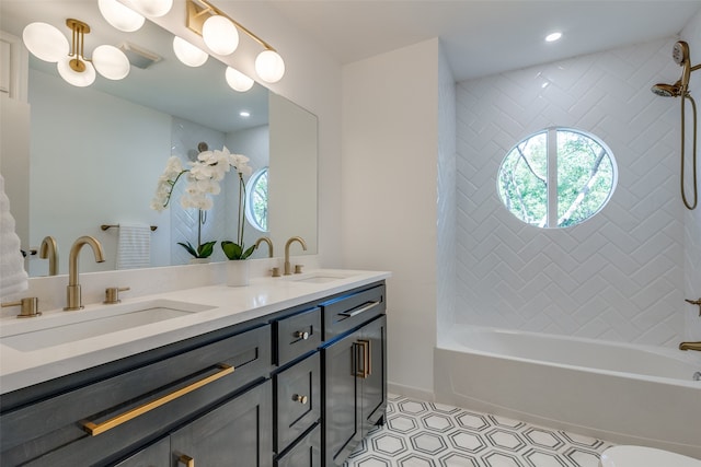 bathroom featuring vanity, tile patterned floors, and tiled shower / bath