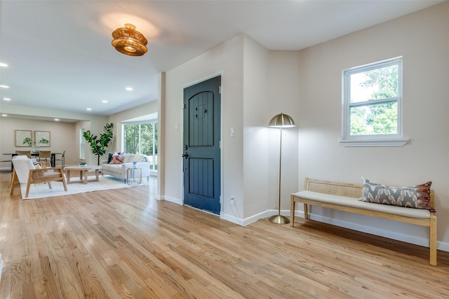 entryway featuring baseboards, light wood finished floors, and recessed lighting