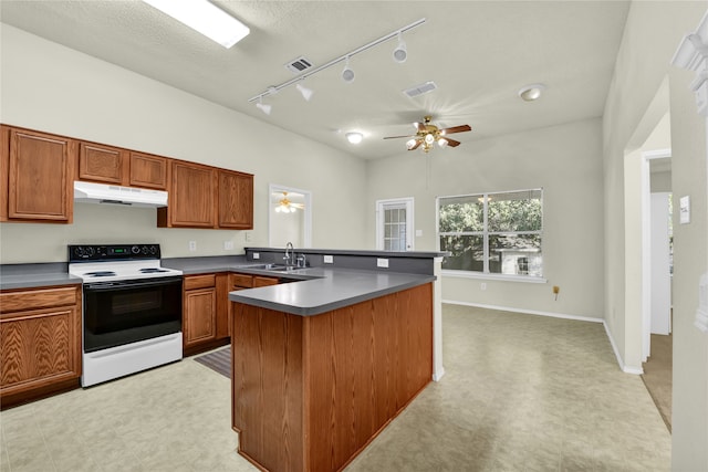 kitchen featuring track lighting, ceiling fan, a textured ceiling, electric stove, and sink