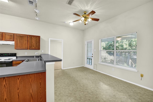 kitchen with electric range, rail lighting, ceiling fan, a textured ceiling, and sink