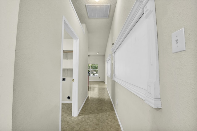 hallway featuring light colored carpet