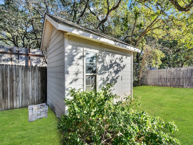 view of outdoor structure featuring a lawn