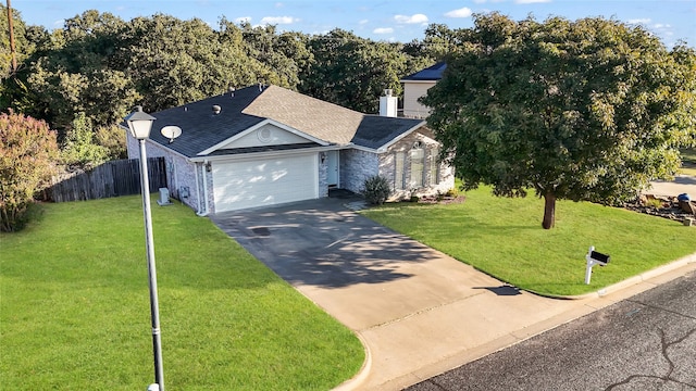 view of front of property with a garage and a front lawn