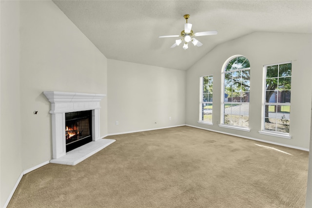 unfurnished living room with carpet floors, ceiling fan, and vaulted ceiling