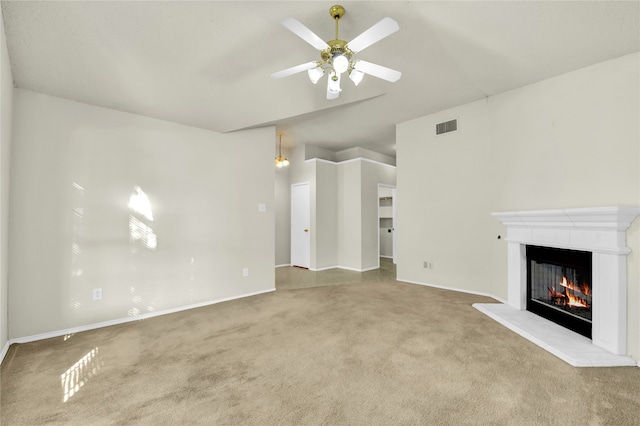 unfurnished living room featuring light carpet and ceiling fan