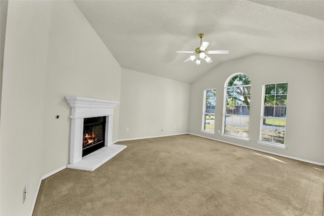 unfurnished living room featuring lofted ceiling, carpet floors, and ceiling fan