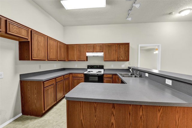 kitchen with kitchen peninsula, sink, rail lighting, white electric stove, and a textured ceiling