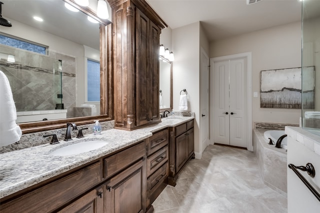 bathroom featuring vanity, independent shower and bath, and tile patterned flooring