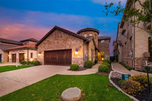 mediterranean / spanish house featuring an attached garage, stone siding, concrete driveway, and a tiled roof