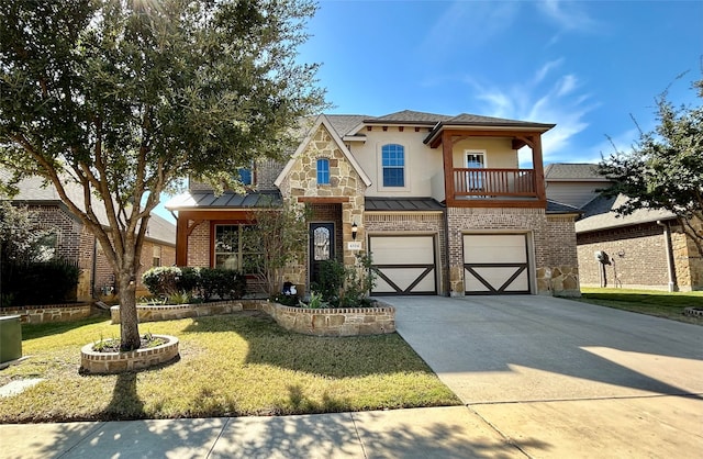 view of front of home featuring a balcony, a front lawn, and a garage