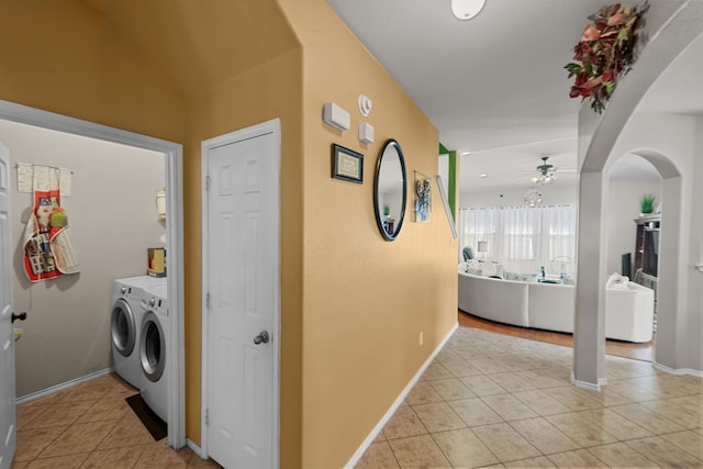 washroom with light tile patterned flooring, washing machine and dryer, and ceiling fan