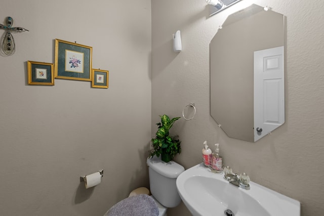 bathroom with toilet and sink