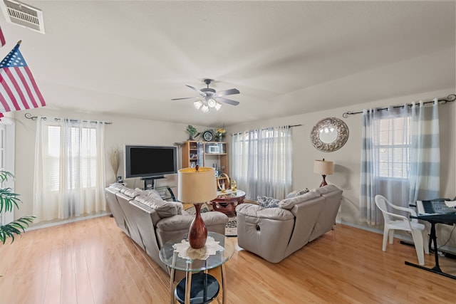 living room with hardwood / wood-style flooring, a healthy amount of sunlight, and ceiling fan