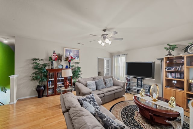 living room featuring light wood-type flooring and ceiling fan