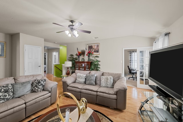 living room featuring light hardwood / wood-style floors, lofted ceiling, and ceiling fan