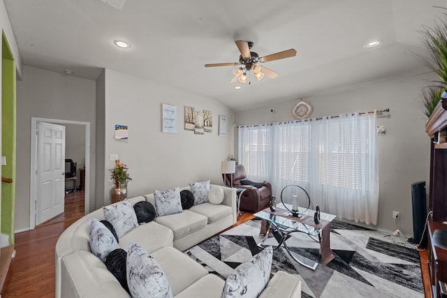 living room featuring hardwood / wood-style flooring, ceiling fan, and vaulted ceiling