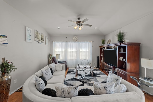 living room with lofted ceiling, hardwood / wood-style floors, and ceiling fan