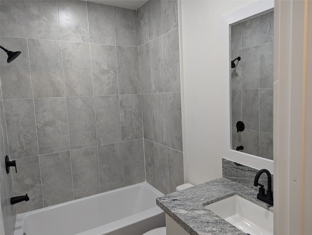 full bathroom with vanity, tiled shower / bath combo, and toilet