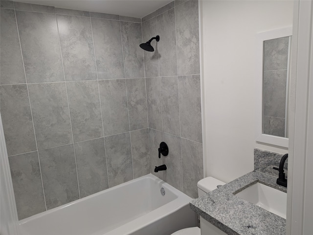 full bathroom with vanity, tiled shower / bath combo, and toilet