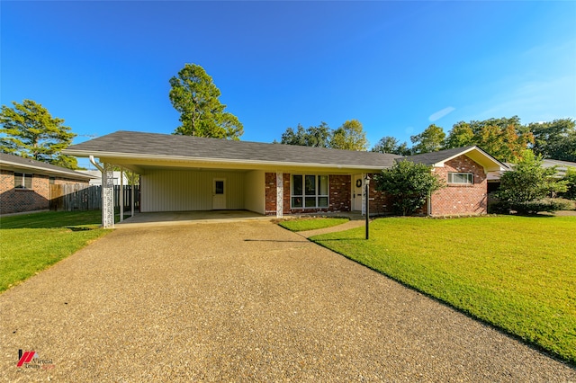 ranch-style house featuring a front yard and a carport