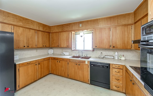 kitchen featuring tasteful backsplash, black appliances, and sink