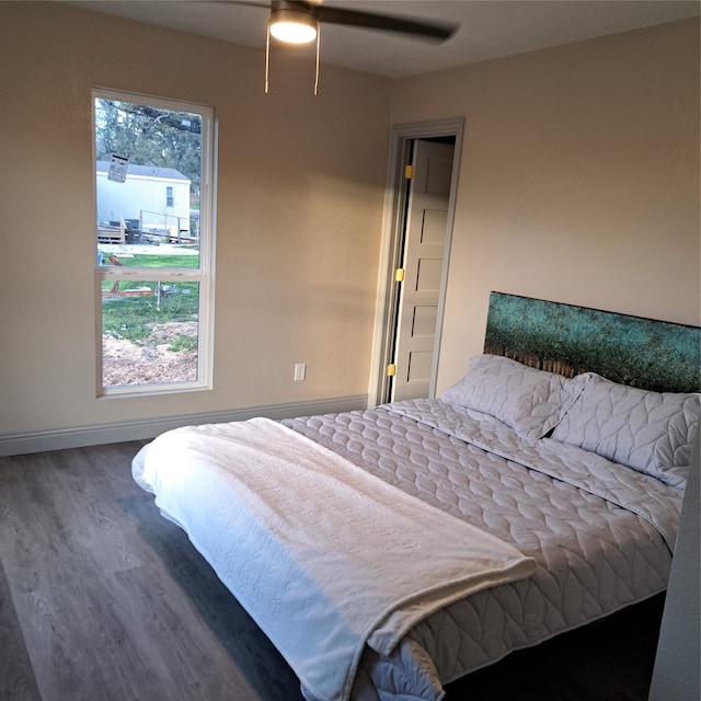 bedroom with ceiling fan and dark hardwood / wood-style floors