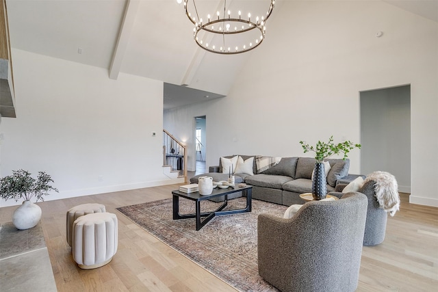 living room featuring beam ceiling, light hardwood / wood-style flooring, high vaulted ceiling, and a notable chandelier