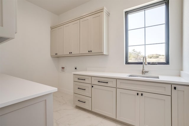 washroom featuring cabinets, washer hookup, electric dryer hookup, and sink