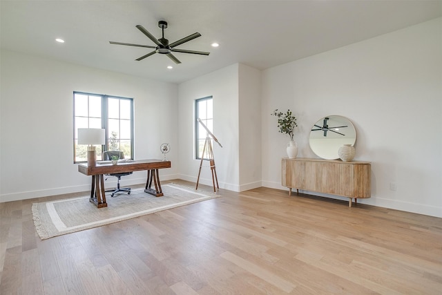 office space with light wood-type flooring and ceiling fan