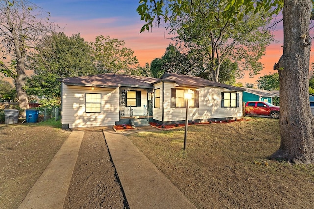 ranch-style home with a lawn