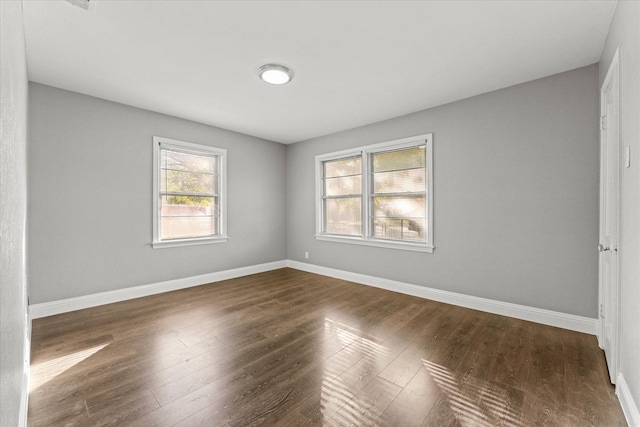 empty room with dark hardwood / wood-style floors