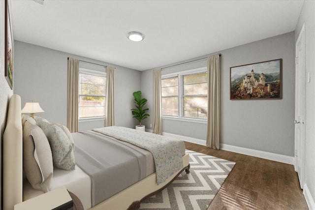 bedroom with dark hardwood / wood-style floors