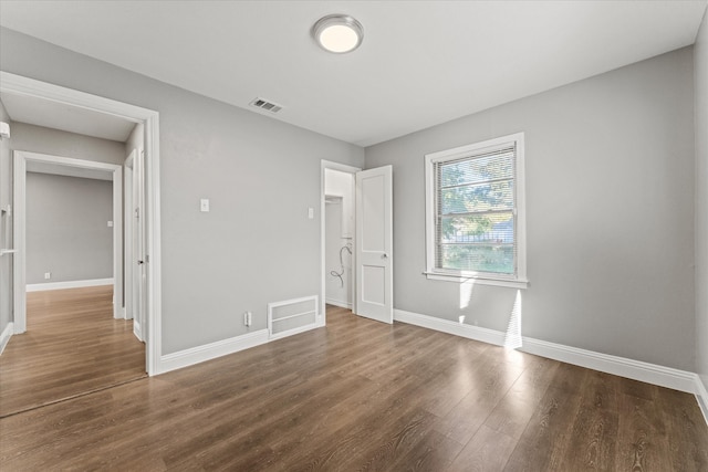 unfurnished bedroom with dark wood-type flooring