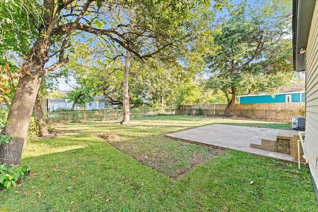 view of yard featuring cooling unit and a patio