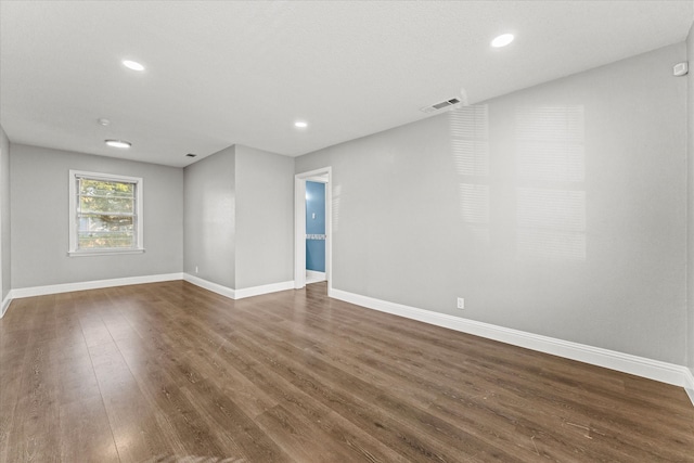 empty room featuring dark hardwood / wood-style flooring