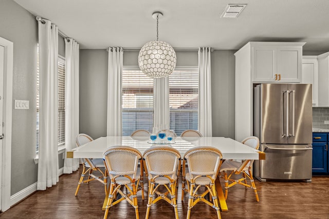 dining space featuring dark wood-type flooring