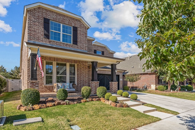 craftsman house featuring covered porch and a front lawn