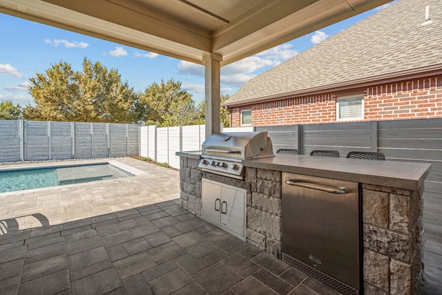 view of patio / terrace featuring area for grilling and a fenced in pool