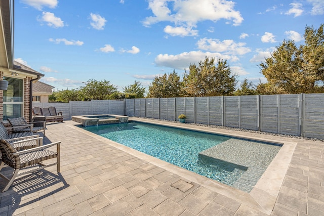 view of pool with an in ground hot tub and a patio