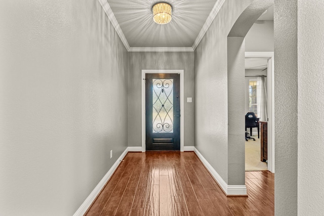 foyer featuring crown molding and wood-type flooring