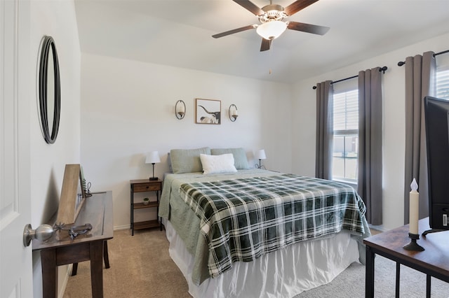 bedroom with ceiling fan and light colored carpet