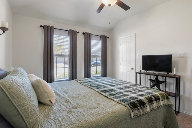 carpeted bedroom with ceiling fan and vaulted ceiling