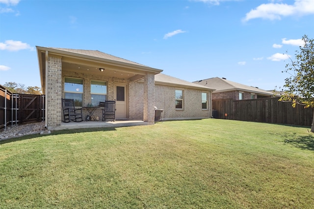 back of property featuring a patio and a lawn