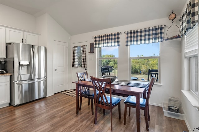 dining area with lofted ceiling and dark hardwood / wood-style flooring