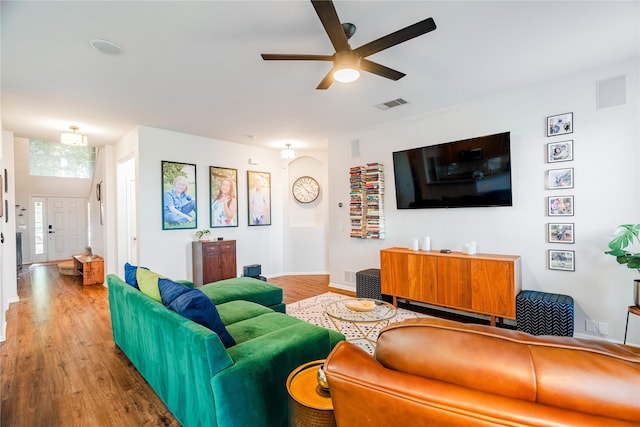 living room with light hardwood / wood-style flooring and ceiling fan