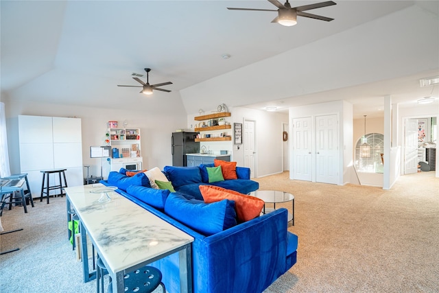 living room with ceiling fan, lofted ceiling, and light carpet