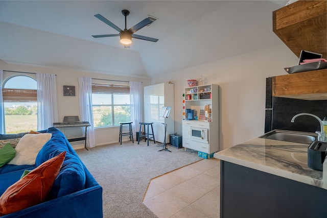 living room featuring light carpet, plenty of natural light, lofted ceiling, and sink