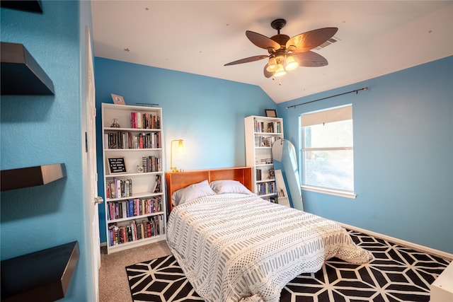 bedroom with ceiling fan, carpet floors, and lofted ceiling