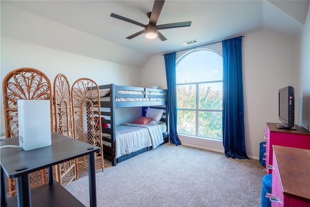 carpeted bedroom with ceiling fan and lofted ceiling